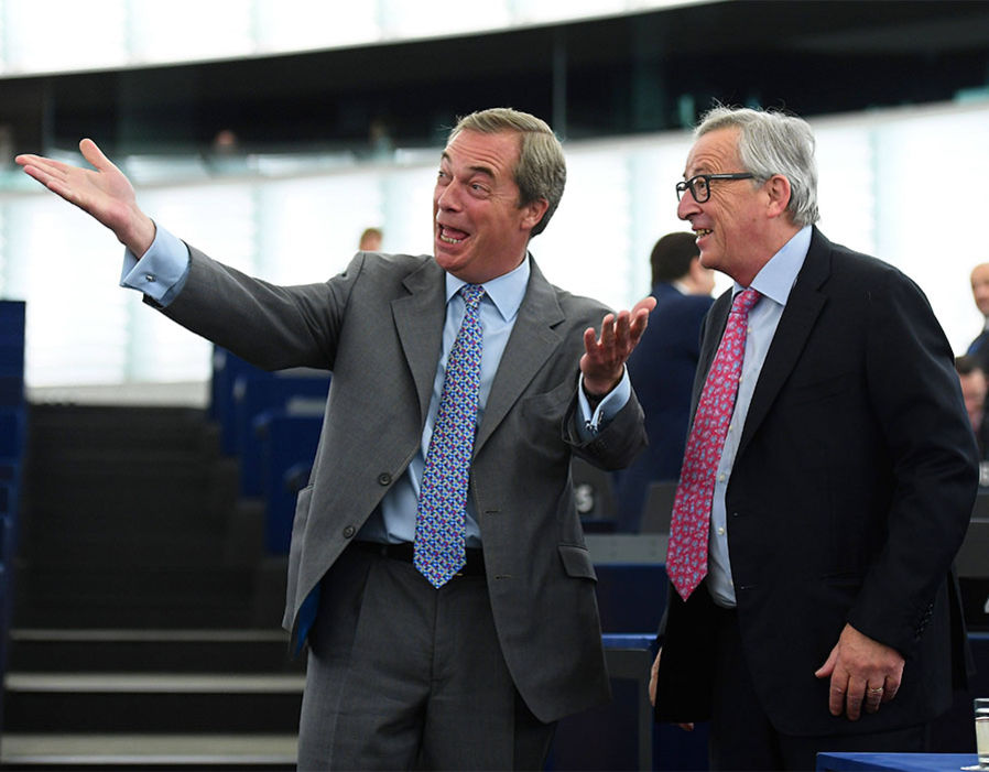 Former leader of the UK Independence Party (UKIP) Nigel Farage (L) gestures as he speaks with EU Commission president Jean-Claude Juncker (R) prior to a debate on the conclusions of the last European Council, at the European Parliament in Strasbourg