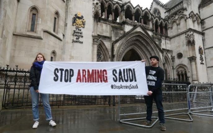 campaigners holding a banner outside the High Court in London