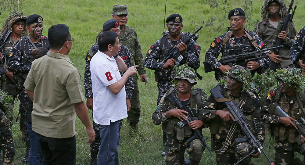 Philippine President Rodrigo Duterte talks to the Philippine Army Scout Rangers at their headquarters at Camp Tecson in San Miguel township, north of Manila, Philippines Thursday, Sept. 15, 2016