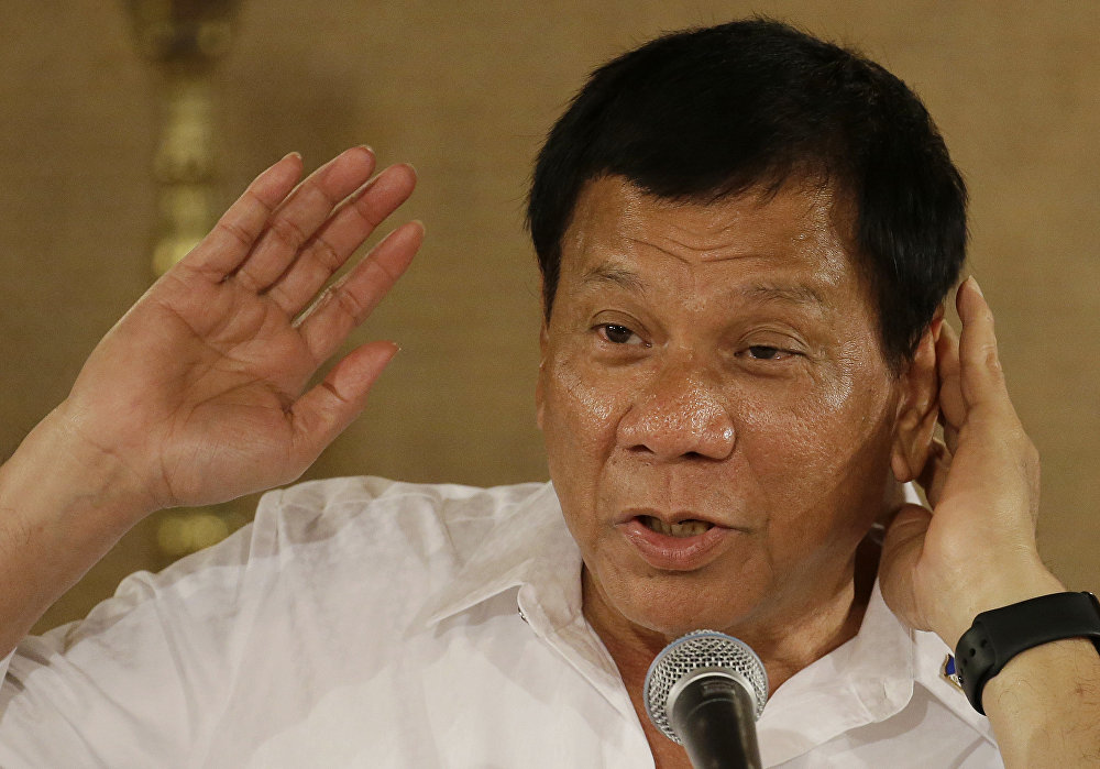 Philippine President Rodrigo Duterte gestures as he answers questions from reporters during a press conference
