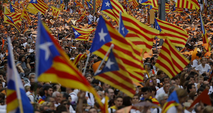 People wave pro-independence Catalan flags, known as the Estelada flag, during a rally calling for the independence of Catalonia, in Barcelona, Spain.