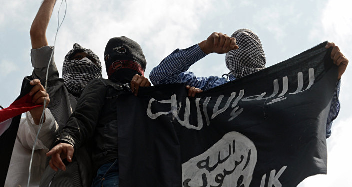Kashmiri demonstrators hold up a flag of the Islamic State of Iraq and the Levant (ISIL) during a demonstration against Israeli military operations in Gaza, in downtown Srinagar on July 18, 2014