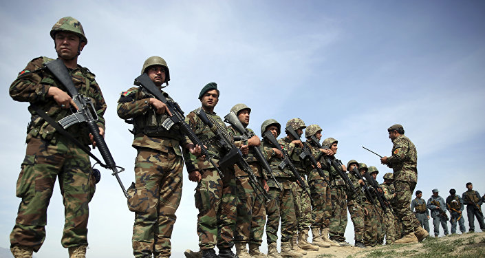 In this Tuesday, Mar. 15, 2016 file photo, Afghanistan's National Army soldiers stand guard, following weeks of heavy clashes to recapture the area from Taliban militants in Dand-e Ghouri district in Baghlan province, north of Kabul, Afghanistan
