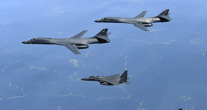 In this June 20, 2017 file photo provided by South Korean Defense Ministry, U.S. Air Force B-1B bombers, top, and second from top, and South Korean fighter jets F-15K fly over the Korean Peninsula, South Korea