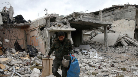 FILE PHOTO: A man walks on rubble of damaged buildings in the town of Douma, Eastern Ghouta © Bassam Khabieh